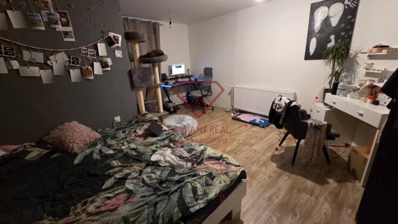 Schlafzimmer im Einfamilienhaus mit Computertisch, Dekorationen und Boden mit Holzdekor.