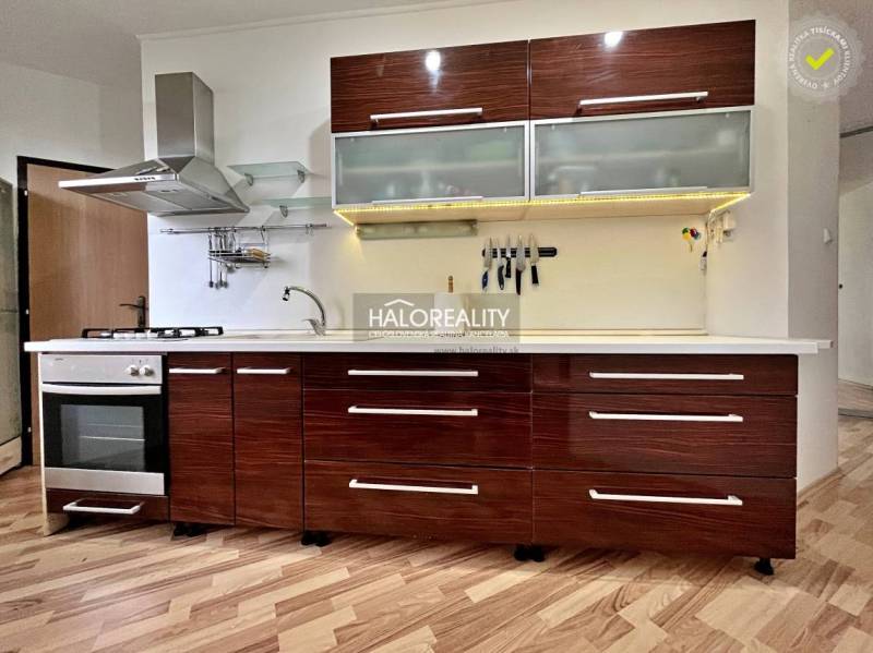 Küche in einer 3-Zimmer-Wohnung mit Küchenzeile und Boden in Holzoptik.