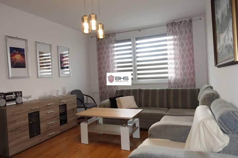 Helles Wohnzimmer mit Ecksofa, Couchtisch und Kommode in einer 3-Zimmer-Wohnung.