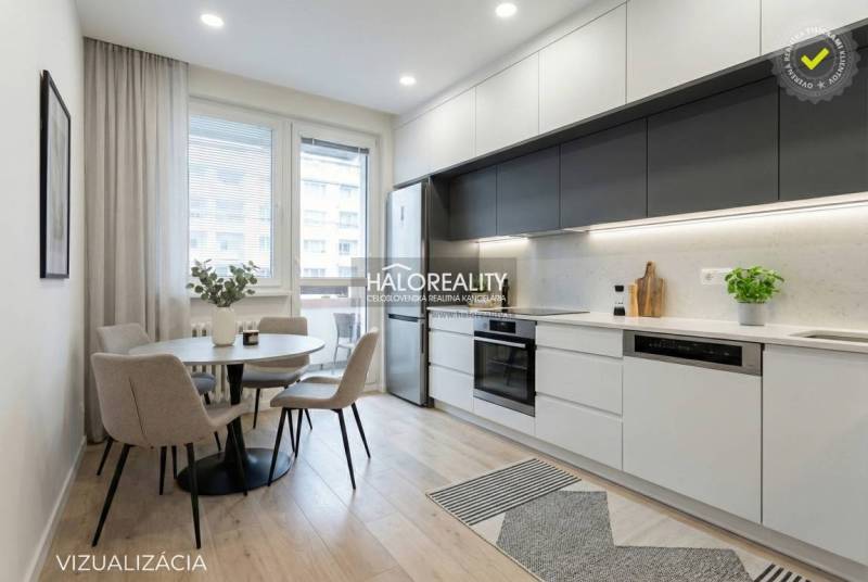 Essbereich mit rundem Tisch und Küche mit Küchenzeile in einer 3-Zimmer-Wohnung.