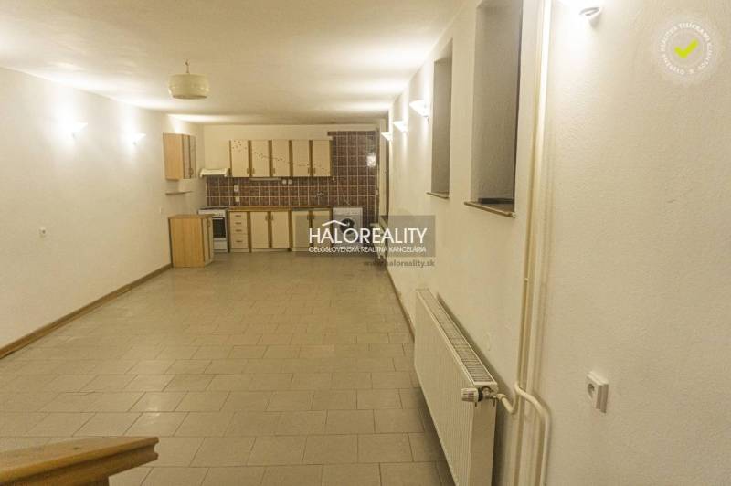 Geräumige Küche und Esszimmer in einem Einfamilienhaus mit Fliesenboden und heller Beleuchtung.