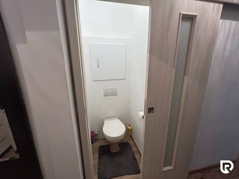 Toilette mit Holzboden in einer Einzimmerwohnung.