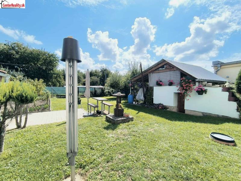 Garten in Partizánske mit Pavillon und Blumenschmuck bei einem Einfamilienhaus.