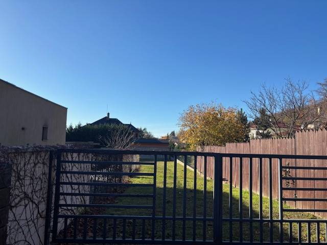 Das Grundstück in der Karpatská-Straße in Marianka ist von Grundstücken mit Wohnhäusern und grünem Rasen umgeben.