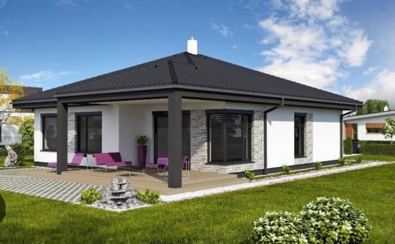 Ein Einfamilienhaus in Most pri Bratislave mit Terrasse, Rasen und Sitzgelegenheit im Freien.