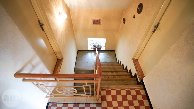 Treppe mit Holzgeländer und Boden mit Holzdekor in einem Einfamilienhaus.