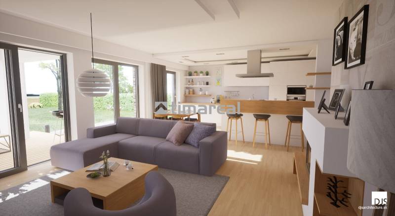 Wohnzimmer mit Holzboden und Kücheninsel in einem Einfamilienhaus.