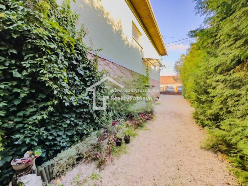 Der Garten beim Einfamilienhaus in Betliar mit reichem Bewuchs und Blumendekorationen.