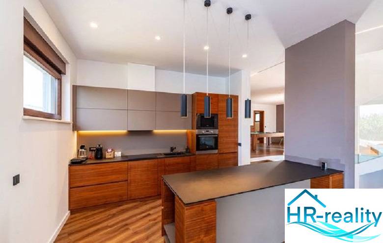 Küche in der Villa mit Holzboden und stilvoller Beleuchtung.