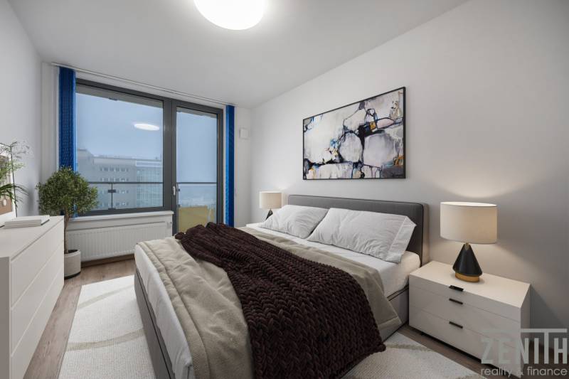 Schlafzimmer in einer 2-Zimmer-Wohnung mit einem bequemen Bett, einem Bild und einer Lampe auf dem Nachttisch.