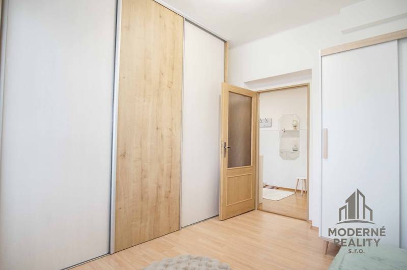 Innenraum einer 4-Zimmer-Wohnung mit Holzboden und Schiebetüren.