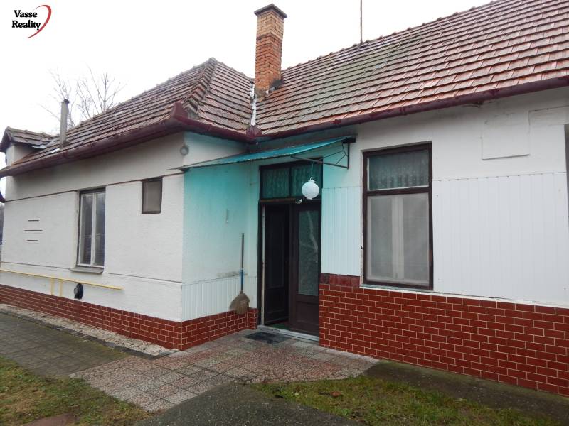 Ein Einfamilienhaus in Kravany nad Dunajom mit einem Ziegeldach und einem gepflasterten Eingang.
