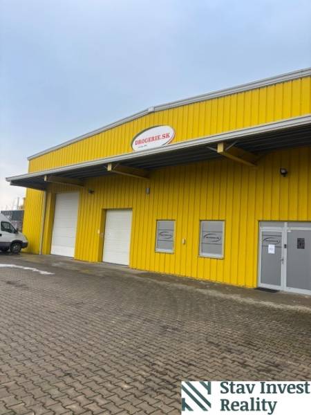 Gelbes Lager- und Hallengebäude an der Poľná-Straße in Senec mit Eingangstoren.