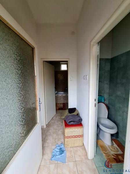 Badezimmer und Toilette mit Fliesen im Einfamilienhaus, mit einem Aufbewahrungskorb.