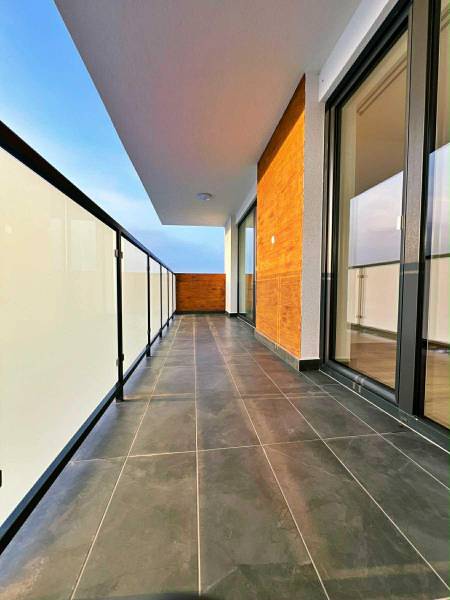 Sicheres Balkongeländer und dunkle Fliesen auf dem Balkon einer 3-Zimmer-Wohnung.