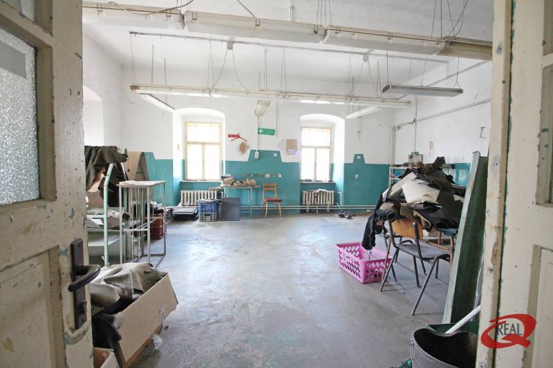 Verlassener Raum in einem Gebäude mit weißen Wänden und blauen Details.