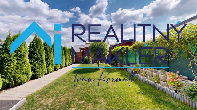 Der Garten eines Einfamilienhauses in Stupava mit gepflegtem Rasen und Bepflanzung.