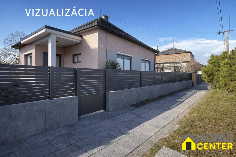 Ein Einfamilienhaus in Iža mit einem modernen Zaun und einem gepflegten Gehweg.