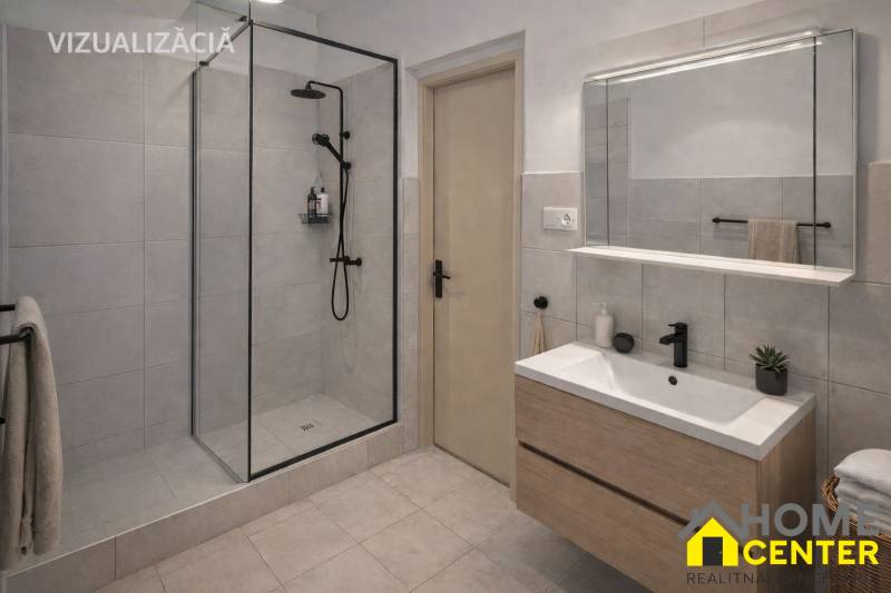 Badezimmer in einem Einfamilienhaus mit moderner Duschkabine und Waschbecken mit Stauraum.