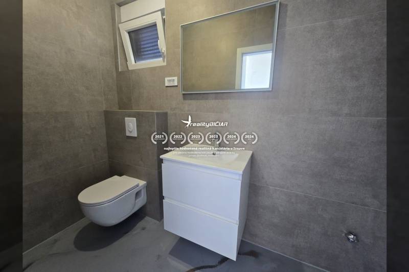 Badezimmer in der Villa mit modernem Waschbecken, hängendem WC und Spiegel an der Wand.