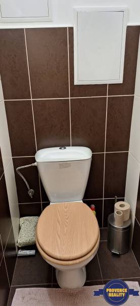 Toilette mit Holzboden in einer 4-Zimmer-Wohnung.