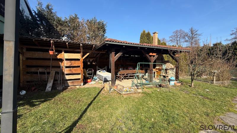 Der Garten eines Einfamilienhauses in Lutila mit einem Holzunterstand und einer Schaukel auf dem Grundstück.