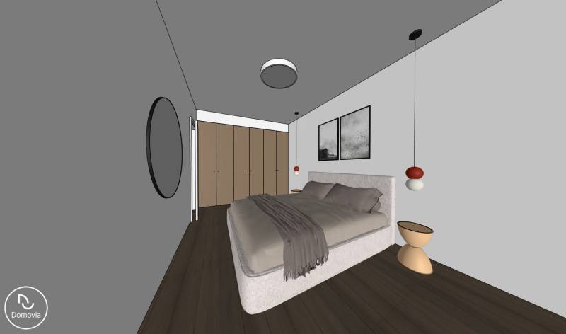 Schlafzimmer in einer 2-Zimmer-Wohnung mit Holzboden und grauen Wänden.