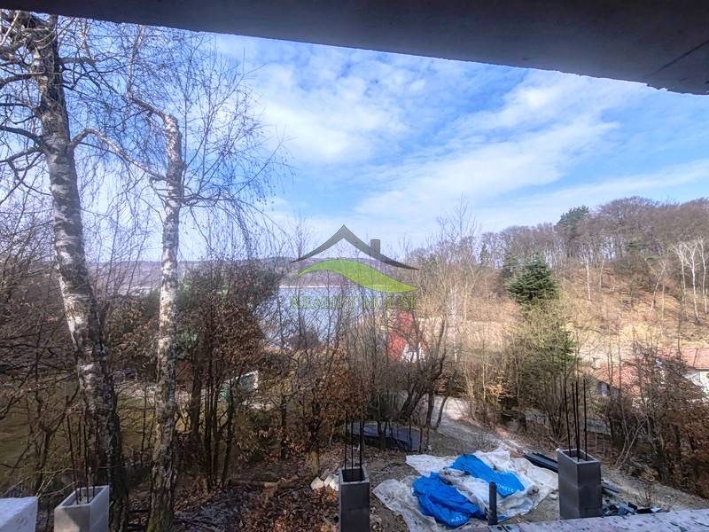 Blick auf den See von der Hütte auf dem Hasenhang in Holčíkovce, umgeben von Wald.