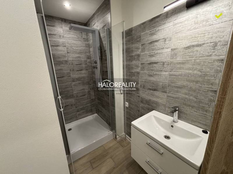 Badezimmer mit Dusche und Waschbecken in einer 3-Zimmer-Wohnung.