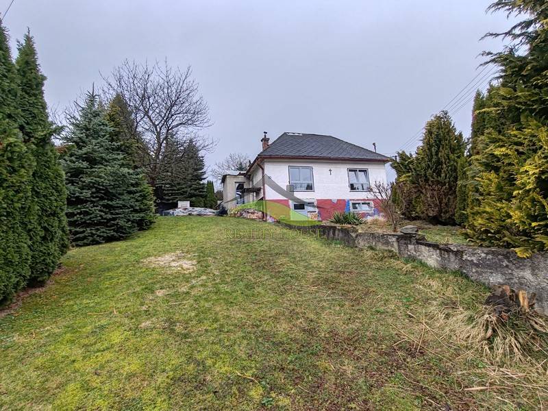 Das Einfamilienhaus in der Hauptstraße in Piskorovce, umgeben von Bäumen und einem begrünten Hof.