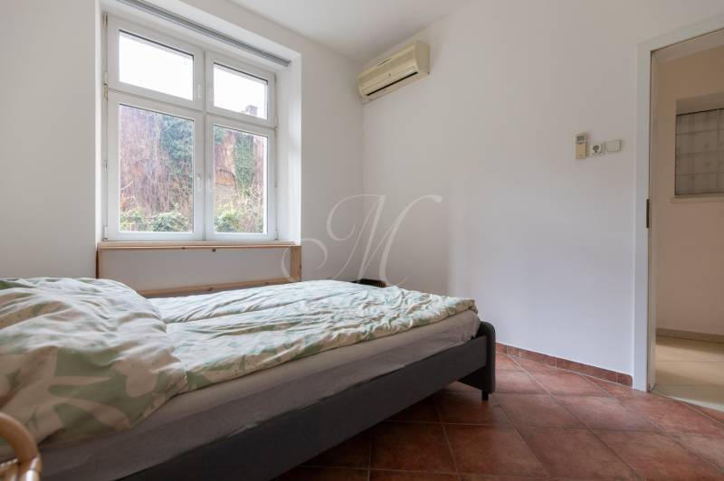 Schlafzimmer in einer 4-Zimmer-Wohnung mit Klimaanlage und Blick in den Garten.