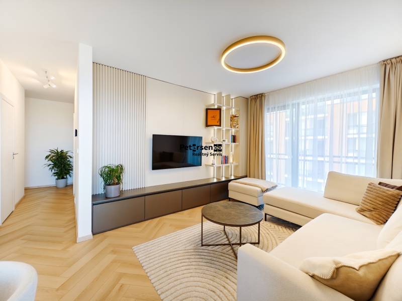 Wohnzimmer in einer 2-Zimmer-Wohnung mit Holzboden und geräumigem Sofa.