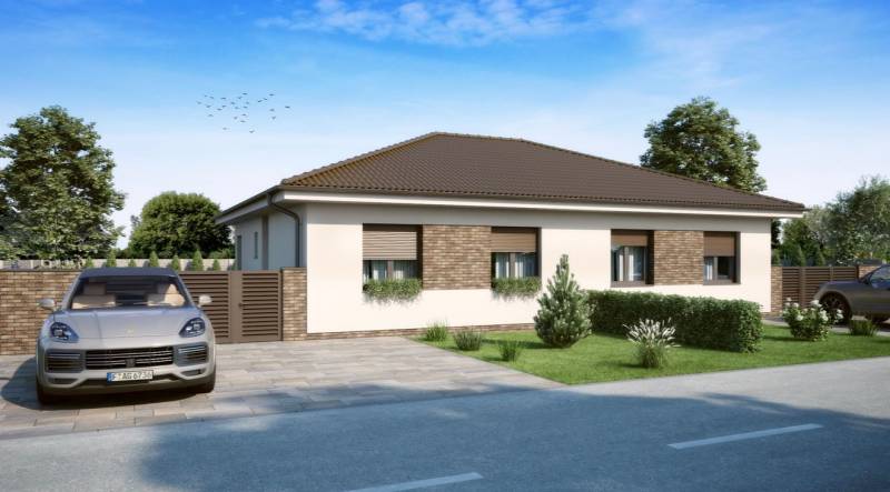 Ein Einfamilienhaus in Veľké Dvorníky mit Ziegelverkleidung und einem Auto in der Garage.