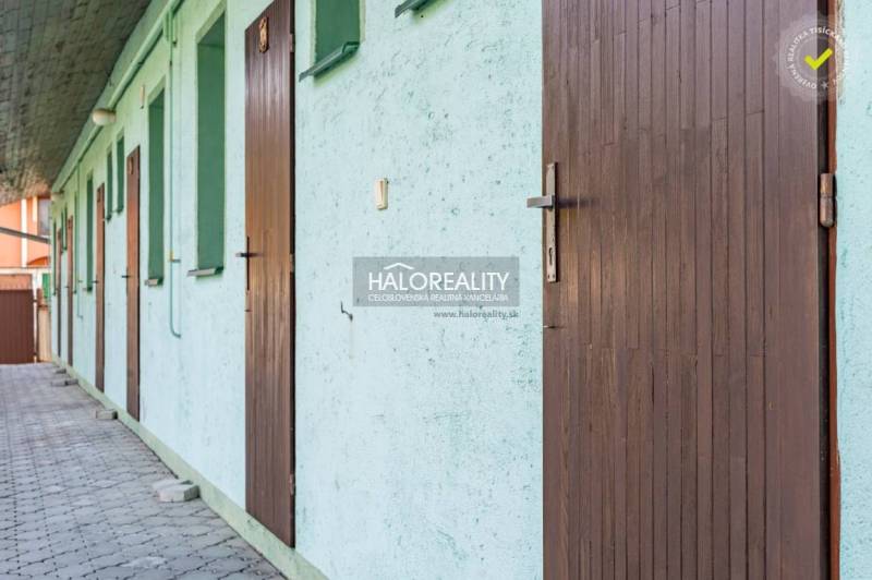 Ein Gehweg mit nebeneinanderliegenden Türen in einer Unterkunft in Veľký Meder, Hotels und Pensionen.