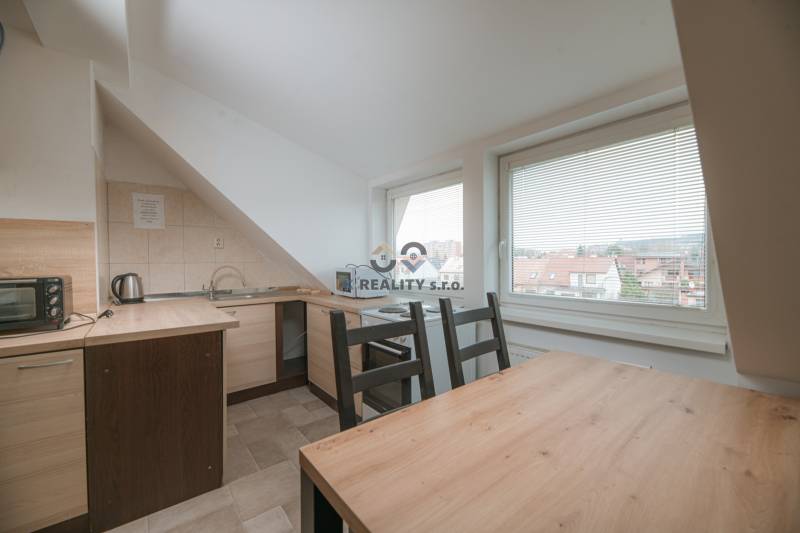 Küche in einer 2-Zimmer-Wohnung mit Holzboden, große Fenster mit Aussicht.