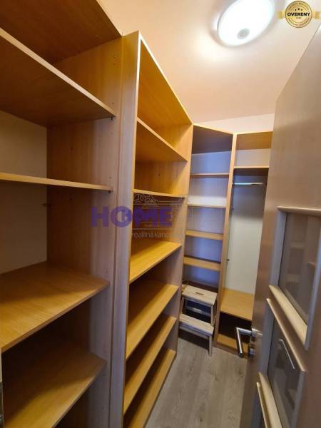 Stauraum mit Regalen in einer 2-Zimmer-Wohnung mit Holzboden.