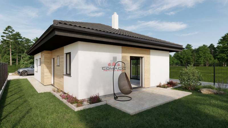 Ein Einfamilienhaus in der Kostolná-Straße in Drahovce mit Terrasse und Gartenmöbeln.