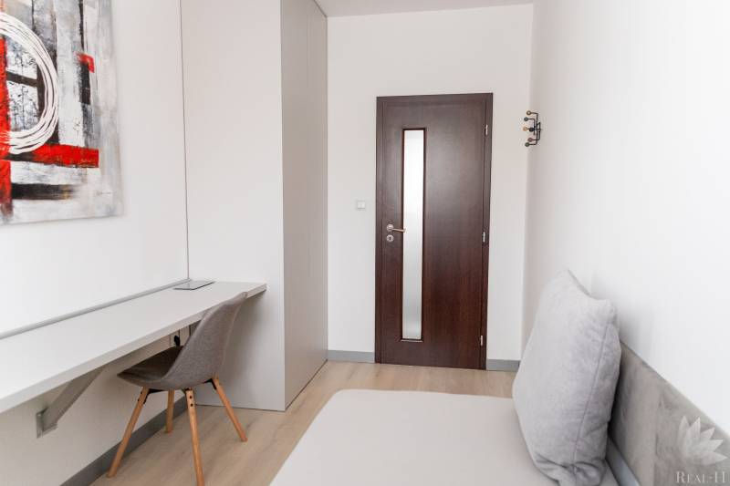 Arbeitsbereich in einer 4-Zimmer-Wohnung mit Holzboden und moderner Kunst.