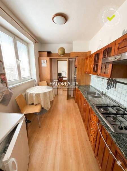 Küche in einer 3-Zimmer-Wohnung mit Holzboden und Esstisch.
