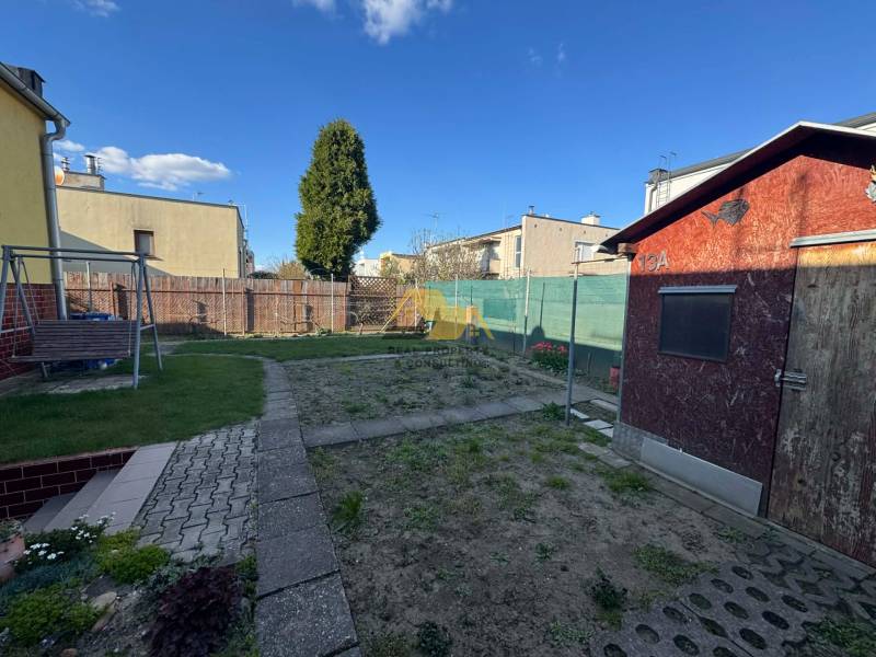 Garten mit Rasen und Holzhäuschen bei einem Einfamilienhaus in Nové Zámky, Straße Nové Zámky.