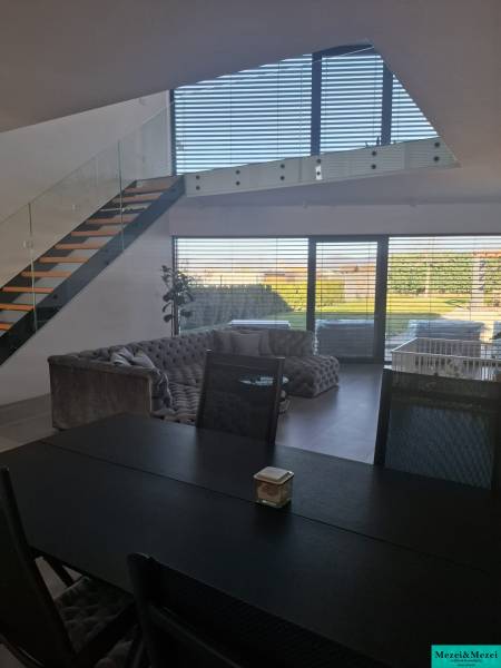 Esstisch und Treppe in einem Einfamilienhaus mit Blick in den Garten.