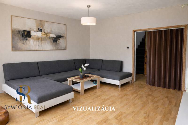 Wohnzimmer mit Ecksofa, Bild und Holzboden in einem Einfamilienhaus.