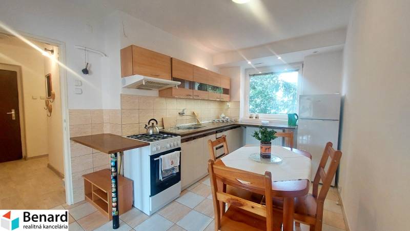 Küche mit Küchenzeile und Esstisch in einer 2-Zimmer-Wohnung.