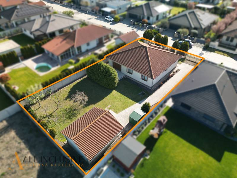 Ein Einfamilienhaus in Kútniky mit Garten und Parkmöglichkeiten, umgeben von einem Zaun.