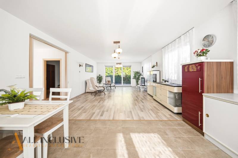 Innenraum eines Einfamilienhauses mit einem hellen Wohnzimmer und einem Boden in Holzoptik.