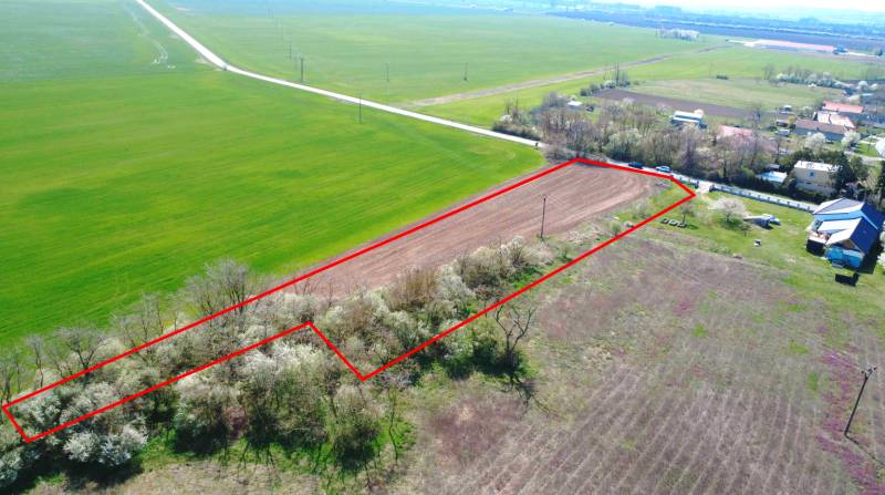 Grundstück im Bereich Záhrady Ondrejovce, umgeben von Feldern und Häusern, begrenzt durch eine rote Linie.