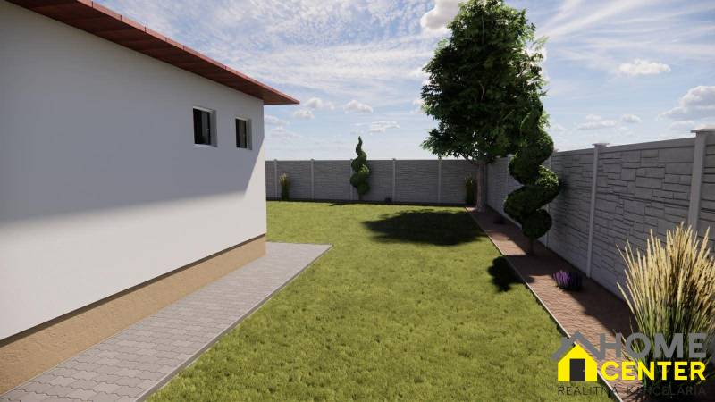 Garten bei einem Einfamilienhaus in Zemianska Olča mit Rasen und Ziersträuchern, umgeben von einem Zaun.