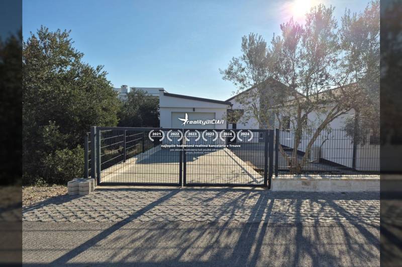 Ein Einfamilienhaus in Vrsi in der Straße Mulo mit Tor, Pflastersteinen und Grünflächen.