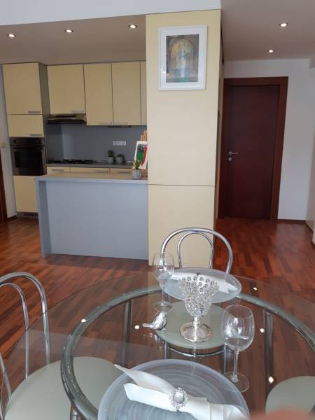 Küche und Essbereich in einer 3-Zimmer-Wohnung mit Holzboden-Dekor.