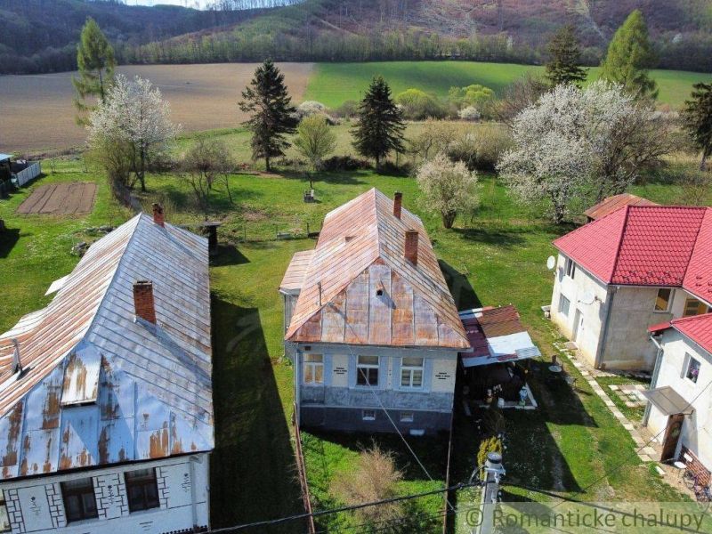 Ein Einfamilienhaus in Zubné, umgeben von Grün und blühenden Bäumen in einer angenehmen ländlichen Landschaft.